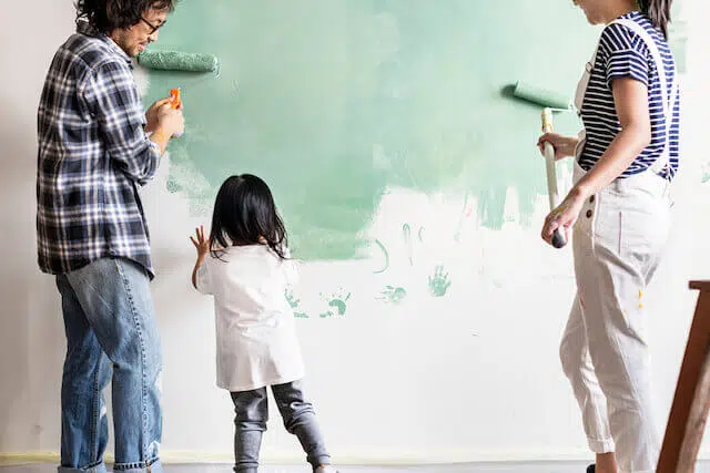 family painting their wall